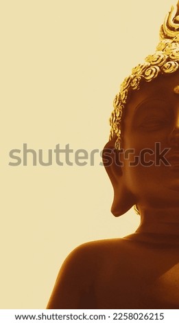 grainy texture buddha background image with warm colour edit and negative space for inserting quotes.beautiful closeup of smiling buddha with highlights and shadows.peaceful buddha backgrounds.