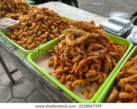 Local street food vendor selling deep fried crispy shrimp and prawn on the Parangtritis Beach, Indonesia.