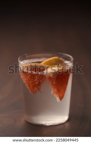 Grapefruit lemonade in tumbler glass on wood table