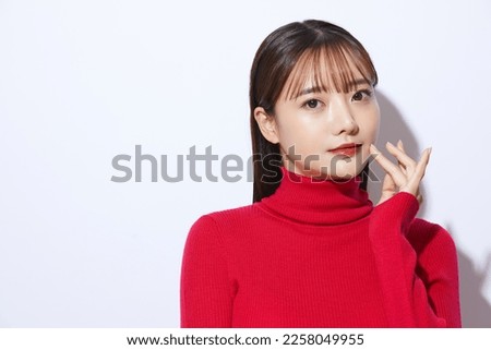 Beauty portrait of young Asian woman in red knit Royalty-Free Stock Photo #2258049955