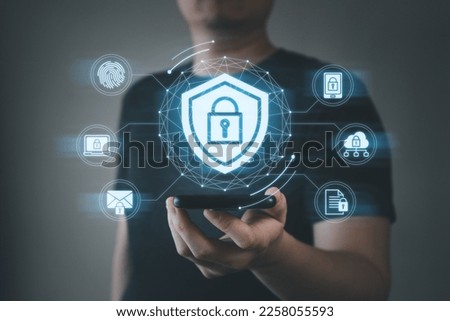 Business man holding mobile phone with padlock network globe shield and security icons in hand. Cyber security, data encryption, business information privacy, network protection concept.