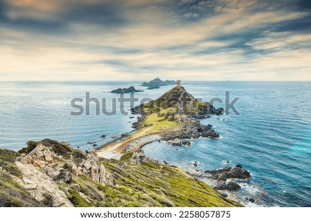 Sunset over popular tourist destination Torra di a Parata with Genoese Tower and Archipelago of Sanguinaires islands at background. Location: Corse-du-Sud, Ajaccio commune, Corsica, France, Europe Royalty-Free Stock Photo #2258057875
