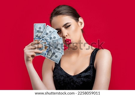 Woman with dollars in hand. Portrait woman holding money banknotes. Girl holding cash money in dollar banknotes. Woman holding lots of money in dollar currency. Luxury, beauty and money concept. Royalty-Free Stock Photo #2258059011