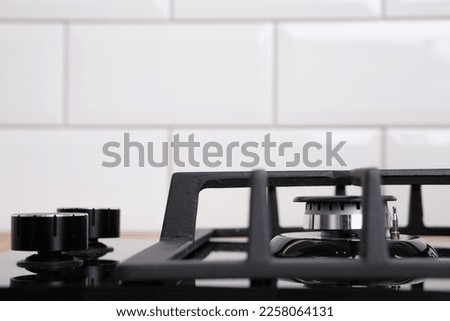 black glass hob built into a wooden worktop in the kitchen.