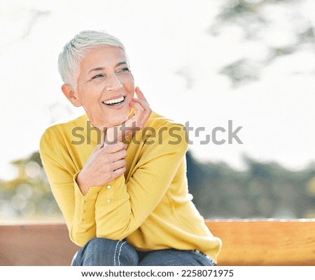 Portrait of an elderly woman outdoors. Happy senior woman in park Royalty-Free Stock Photo #2258071975