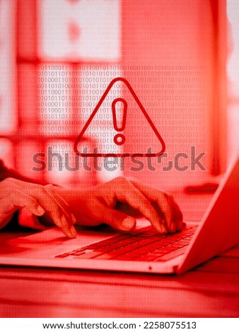 Virus alert. Red triangle, System hacked error sign, malware, attention danger symbol warning showing on binary code while business person working with laptop computer, red tone, vertical style. Royalty-Free Stock Photo #2258075513