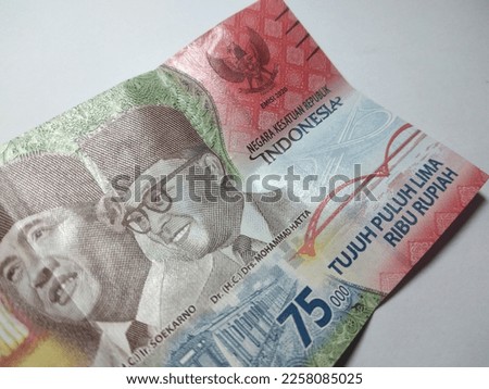 75000 rupiah banknote. Indonesian rupiah currency isolated on a white background, financial management concept. Back view of the 75000 rupiah banknote from Indonesia.