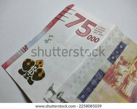 75000 rupiah banknote. Indonesian rupiah currency isolated on a white background, financial management concept. Back view of the 75000 rupiah banknote from Indonesia.