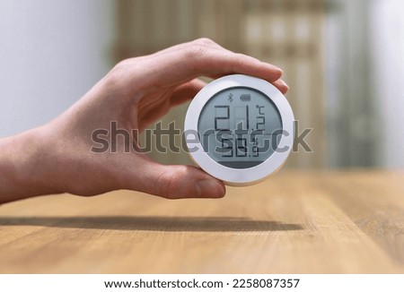 Thermohygrometer, home air quality and humidity control device with normal healthy good numbers of temperature indoor. High quality photo Royalty-Free Stock Photo #2258087357