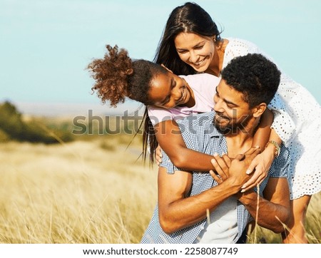 Family having fun outdoors in meadow
