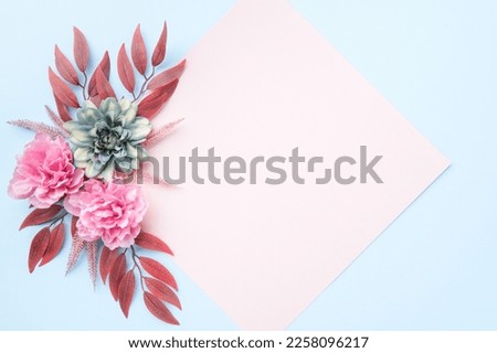 Happy Mother's Day, Women's Day, Valentine's Day or Birthday Pastel Colored Background. Floral flat lay greeting card template with beautiful silk flowers.