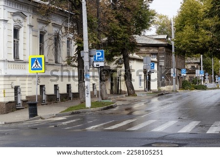 street old houses pedestrian crossing road signs.