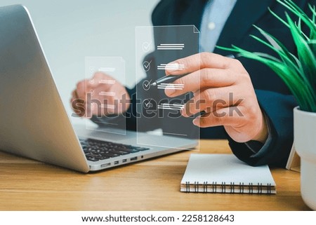 E-document management Paperless workplace, Electronic signature concept, electronic signature, business people sign electronic, Businessman use laptop and hold a pen marking on electronic. Royalty-Free Stock Photo #2258128643