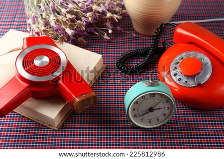 Retro things on table-hairdryer, clock, phone, book