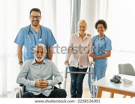 Doctor or nurse caregiver helping  senior people in a wheelchair and a walker at home or nursing home, man with chronic health condition, who is paralyzed Royalty-Free Stock Photo #2258136301