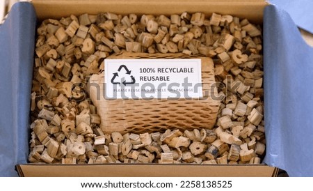Net zero waste go green SME use eco friendly care sign plastic free symbol packaging carton box wrap paper in small shop retail store. Chva dried water hyacinth on desk reuse packing parcel supplies. Royalty-Free Stock Photo #2258138525