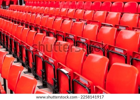 red plastic chair in football, basketball or baseball arena stadium in a row for visitor to visit and enjoy sport match competition for big football match in football stadium
