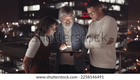 Business team, tablet and night on city building rooftop talking global networking, digital marketing and social media. Man and woman with 5g network on mobile stock market app for innovation idea