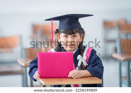 A proud child graduate dressed in gown and cap symbolizing educational success and achievement