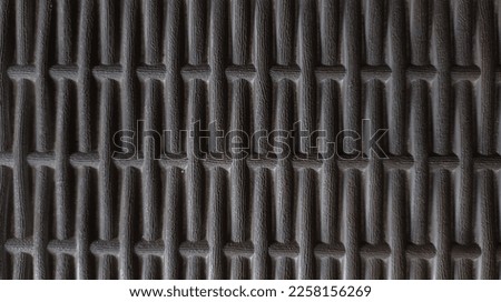 Photo of texture on a plastic chair formed by a neat line pattern