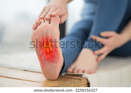 Joint diseases, hallux valgus, plantar fasciitis, heel spur, woman's leg hurts, pain in the foot, massage of female feet at home, health problems concept, BeH3althy Royalty-Free Stock Photo #2258156327