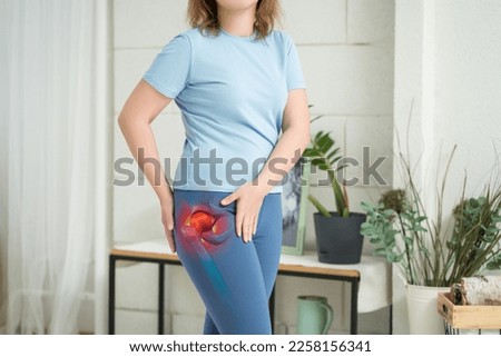 Hip joint pain, woman suffering from osteoarthritis at home, health problems concept Royalty-Free Stock Photo #2258156341