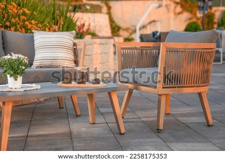 close up,wood sofa and table made of metal and wood in the yard and garden on the garden tiles	 Royalty-Free Stock Photo #2258175353