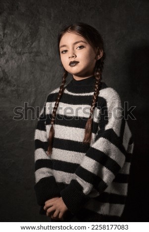 A girl with braids on a dark background Royalty-Free Stock Photo #2258177083