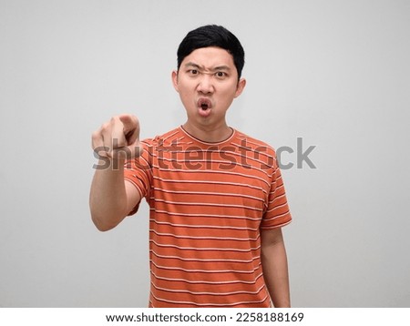 Asian man orange striped shirt angry emotion point finger at you isolated