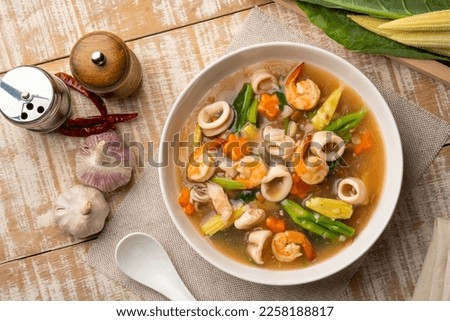 Fried noodles with Shrimp and Squid in thick gravy (Rad-Na Taley) on white plate.Top view Royalty-Free Stock Photo #2258188817