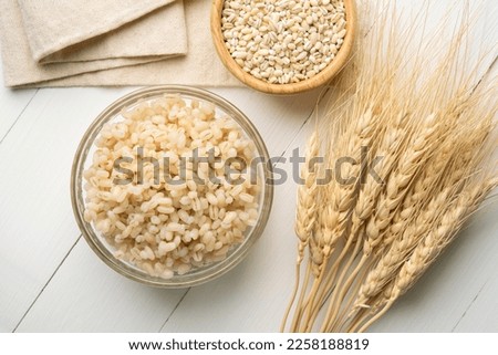 Cooked Pearl barley grains in glass bowl.Top view Royalty-Free Stock Photo #2258188819