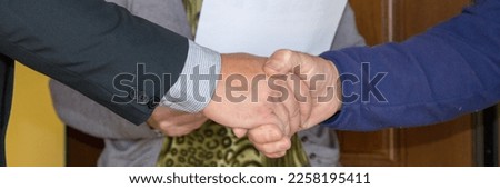 Image of two men shaking hands after concluding a deal. Creation of a sales contract. Horizontal banner 

