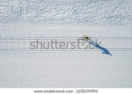 Aerial sportsman with cross country skiing sport background winter forest, top view Royalty-Free Stock Photo #2258195995
