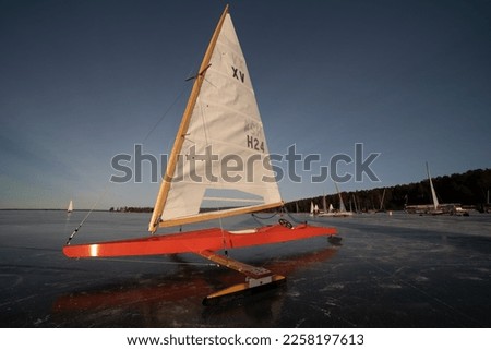 Iceboat at frozen lake with sail