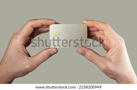 Bank card mockup, sample in men hands closeup. Blank debit credit bankcard with chip of gold color. High quality photo