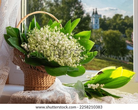 With bouquet of lily of the valley on a windowsill