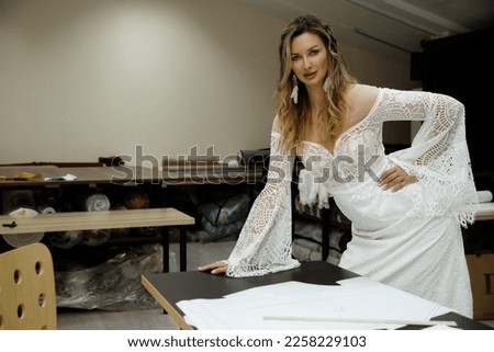 Wedding photo shoot of a bride in a boho wedding dress in a sewing workshop.rl in a boho wedding dress in a sewing workshop.