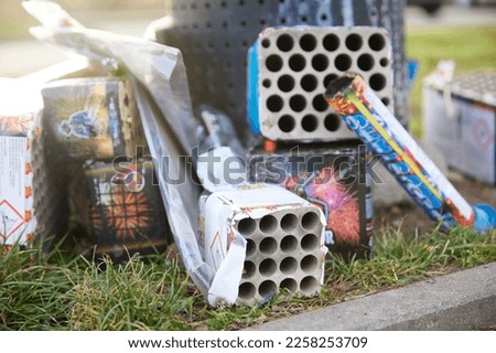 Used fireworks, finished holidays, trash cans filled with trash from the holidays. Royalty-Free Stock Photo #2258253709
