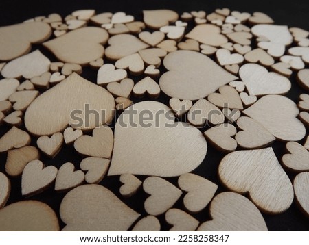 Wooden hearts on a black background as a postcard for the holidays. High quality photo