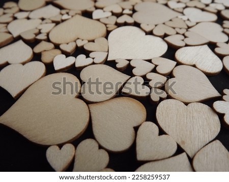 Wooden hearts on a black background as a postcard for the holidays. High quality photo