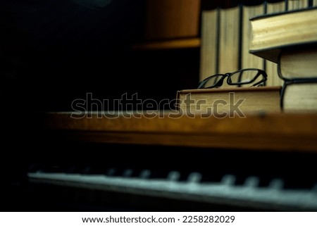 Background with glasses object over thick book on piano table