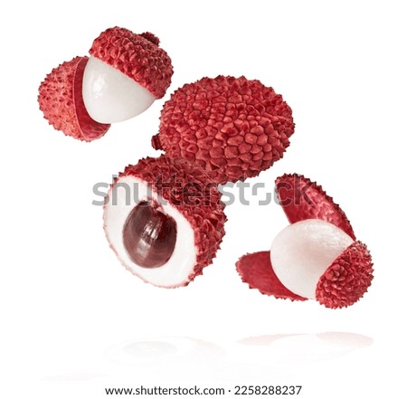 Fresh ripe red lychee falling in the air isolated. Food levitation or zero gravity conception. High resolution image