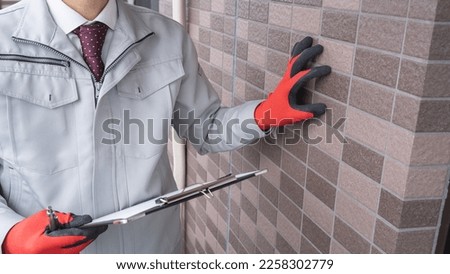 A worker investigating the outer wall. Royalty-Free Stock Photo #2258302779