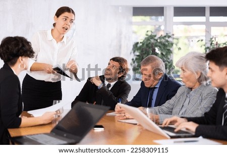 Female corporate worker expressively speaking at team briefing, disagreeing, arguing, blaming others Royalty-Free Stock Photo #2258309115