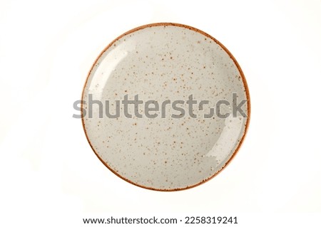 Empty brown ceramic plate isolated on white background. top view Royalty-Free Stock Photo #2258319241