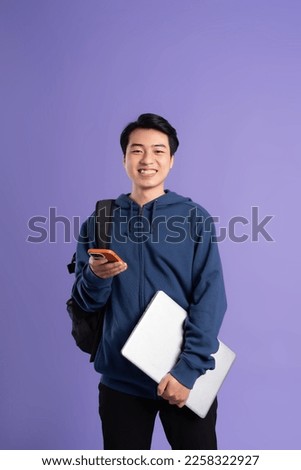 Asian male student portrait on purple background