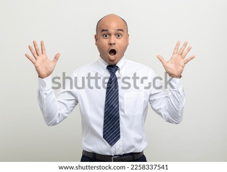 Shocked face. Happy Young asian businessman on isolated white background. Handsome middle aged Indian businessman in office uniform. Royalty-Free Stock Photo #2258337541