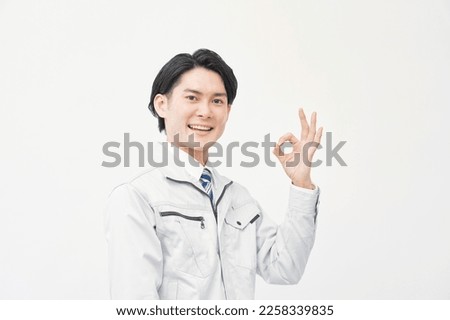 Asian worker OK gesture in white background