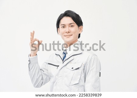 Asian worker OK gesture in white background