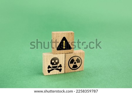 wooden square with caution and toxic  or chemical icons. industrial concepts and hazardous materials